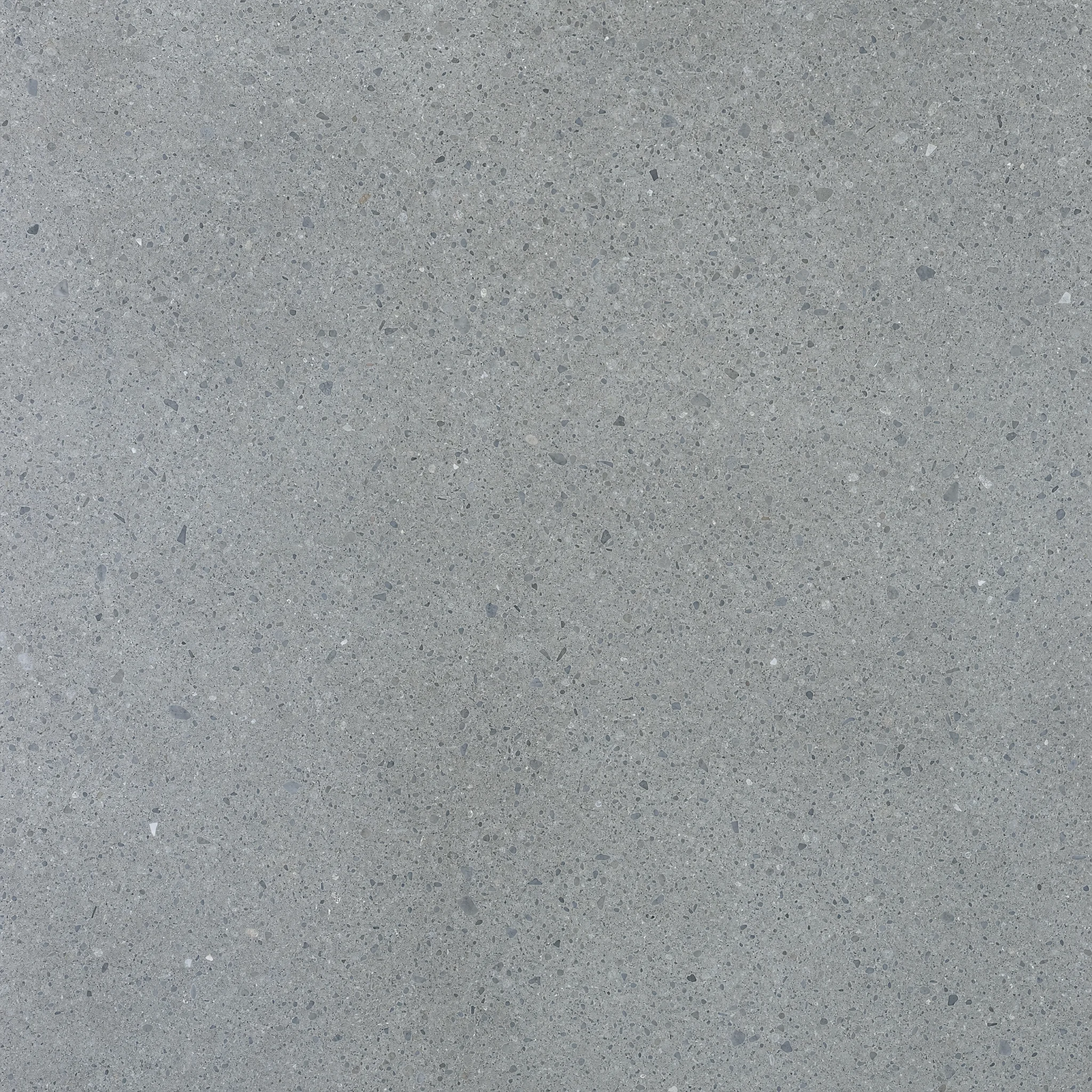 Installer smoothing decorative overlays across a Cook County - IL entry slab for a refined concrete finish
